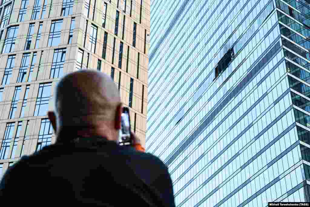 A man looks at the damage from a drone that exploded on impact with a skyscraper in Moscow's International Business Center on August 1. 