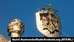 Киевдеги “Украин эне” айкелине эски советтик энбелгинин ордуна эгемен Украинанын үчилтик учтуу энбелгиси чапталды. 06.8.2023.