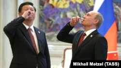 Chinese leader Xi Jinping (left) and Russian President Vladimir Putin in Shanghai following a gas deal signed in 2014. “If they treat Russia as an equal -- even if they don't think they are -- then this will pay dividends for China, and that’s been a growing part of how Xi has approached this entire relationship,” one analyst says.