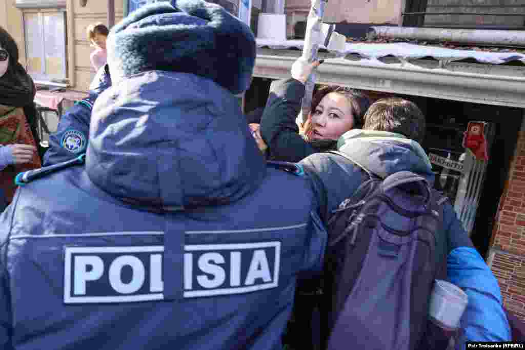 Сотрудники полиции задерживают активисток «Oyan, Qazaqstan»