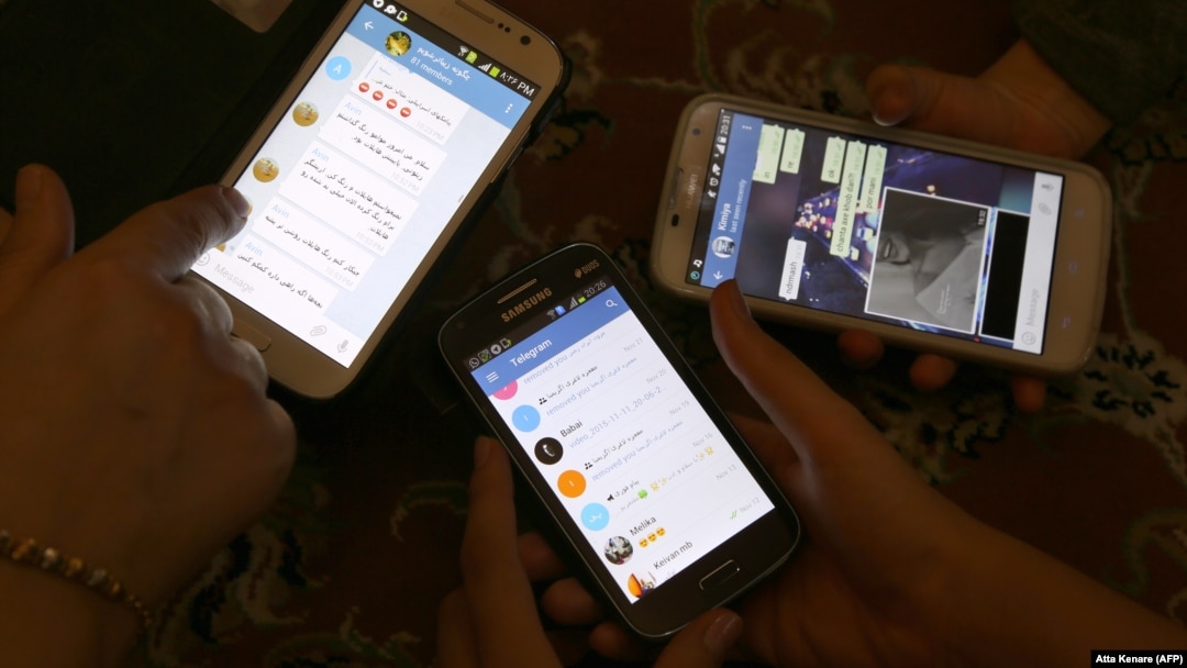 Iranians display their smart phones using the Telegram messenger application, which was officially blocked in the country about a year ago. (file photo)