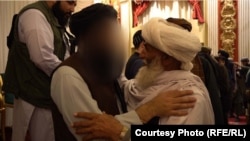 In one of the photos circulated by the Taliban of the October 19 event at Kabul's Intercontinental Hotel, the face of acting Interior Minister Sirajuddin Haqqani is blurred beyond recognition.