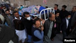 Men carry the body of William Siraj, a priest who was killed by unknown assailants in Peshawar on January 30. 