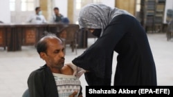 A man receives a dose of the COVID-19 vaccine in Karachi on December 20. 