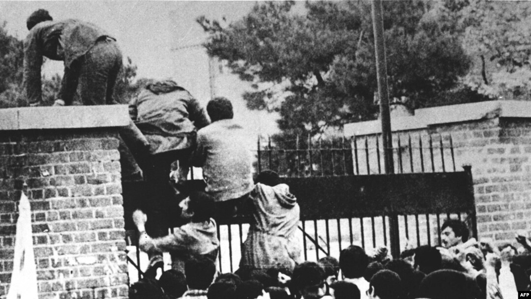 Iranian students climb over the wall of the U.S. Embassy in Tehran on November 4, 1979.