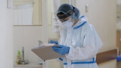 Armenia -- A healthcare worker wearing protective gear takes notes at the Surb Grigor Lusavorich Medical Center, Yerevan, June 5, 2020.