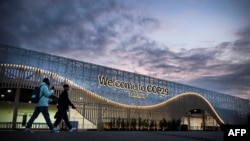 AZERBAIJAN - Pedestrian walk in front of the venue for COP 29 Summit in Baku on November 10, 2024.