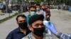 A health worker checks the body temperature of worshippers as a preventive measure against the COVID-19 before the Friday prayers on the first day of the Muslim holy month of Ramadan at Wazir Akbar Khan mosque in Kabul on April 24.