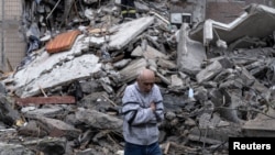 A man walks amid the rubble of a building on May 8 after a Russia air strike on Kostyantynivka.