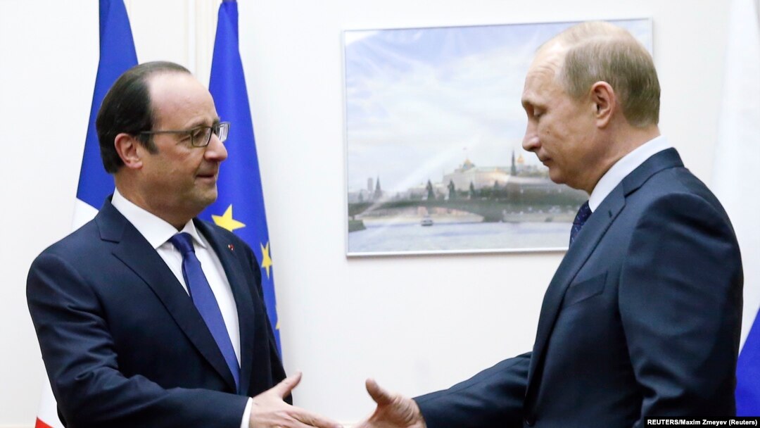French President Francois Hollande (left) shakes hands with Russian President Vladimir Putin when the two met at Moscow's Vnukovo Airport on December 6.