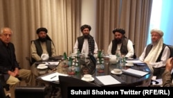 FILE: U.S. peace envoy Zalmay Khalilzad with Taliban leader Mullah Abdul Ghani Baradar and his team during a telephone conversation with the U.S. President Donald Trump in Qatar in March.