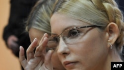 Yulia Tymoshenko listens as the judge reads the verdict on her case in a district court in Kyiv on October 11.