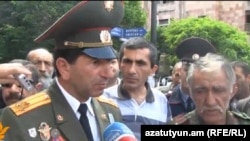 Armenia - Retired Colonel Volodya Avetisian (L) and other war veterans talk to journalists during a demonstration in Yerevan, 13May2013.