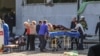 The injured are tended to by rescuers outside the school.