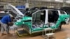 Employees work on an electric vehicle (EV) production line at a factory of Jiangling Group Electric Vehicle in Nanchang, Jiangxi Province, China.