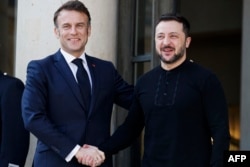 France's President Emmanuel Macron welcomes Ukraine's President Volodymyr Zelenskyy at the Elysee Palace in Paris on March 27.