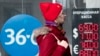 RUSSIA -- A woman walks past an exchange office screen showing the currency exchange rates of U.S. Dollar and Euro to Russian Ruble in Moscow, March 9, 2020