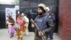 A Pakistani police commando stands guard outside a church during Christmas Mass in Lahore on December 25.