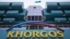 A man is reflected in a window as he walks past the main terminal of the Khorgos border crossing point, east of the country's biggest city and commercial hub Almaty, Kazakhstan, October 19, 2015.