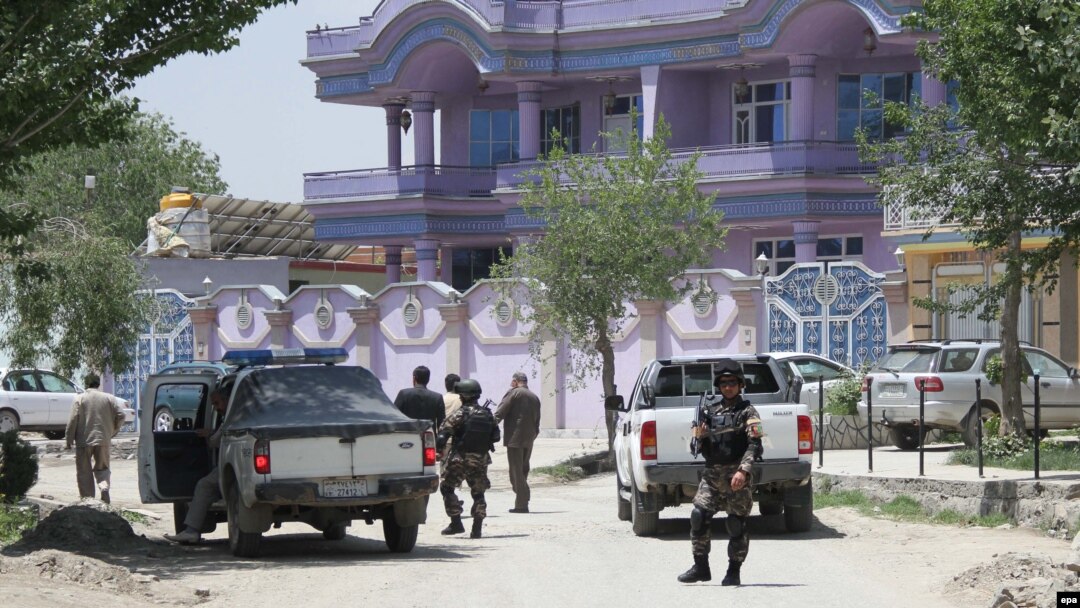 Security officials stand guard in front of the house of Arsala Rahmani, senior peace negotiator, in Kabul, after his murder.